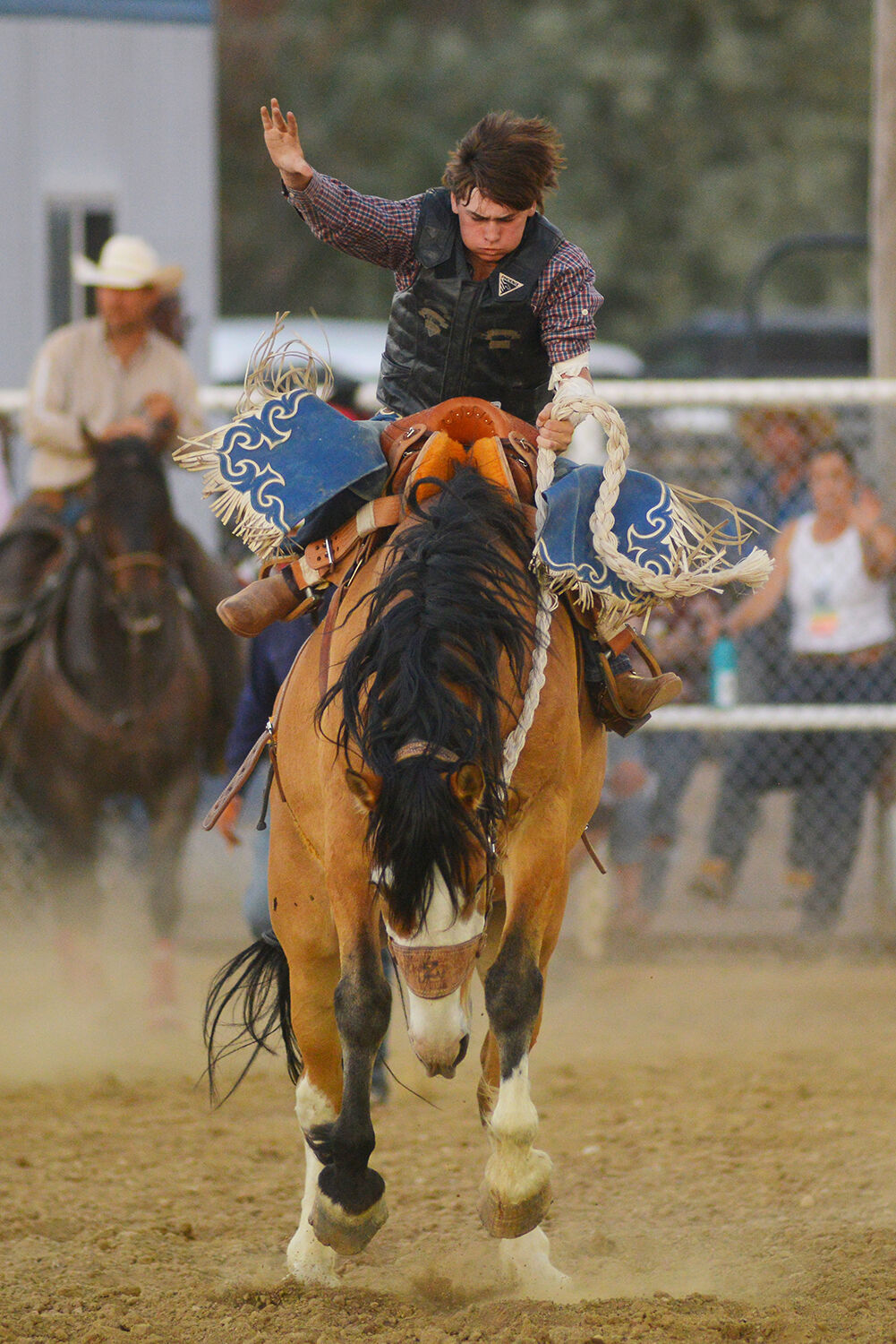 Pace Garrett kicks his feet back and leans forward as his horse jumps